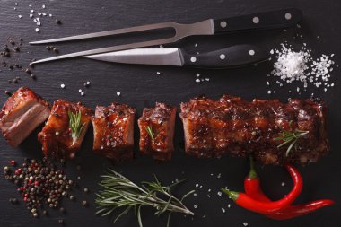 BBQ pork ribs chopped close-up on a table. Horizontal top view clipart