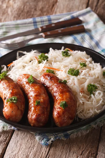 Traditional fried sausage and sauerkraut on a plate. vertical — Stock Photo, Image