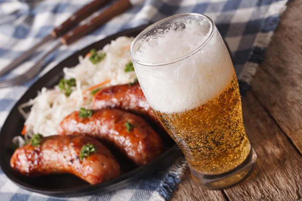 Lager beer and sauerkraut with sausage close-up. horizontal — Stock Photo, Image