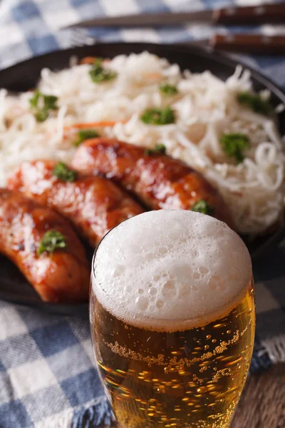 Beer on a background of snack sausages and sauerkraut. Vertical — Stock Photo, Image