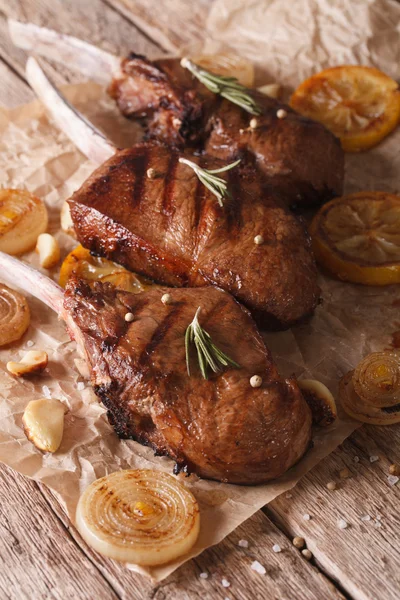 Bistecca di manzo rustica con limone sulla carta primo piano. verticale — Foto Stock