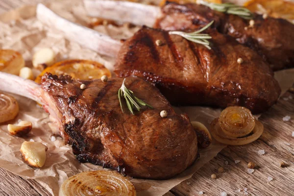 Grilled beef steak with rosemary on a paper close-up. Horizontal — Stock Photo, Image