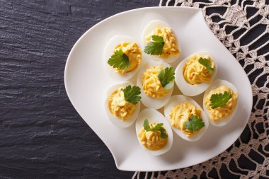 Stuffed eggs with mustard and parsley. Horizontal top view clipart