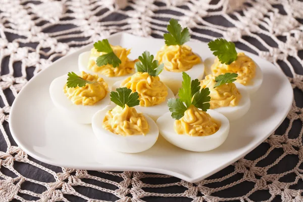 Stuffed eggs decorated with parsley close-up on a plate. horizon — Stock Photo, Image