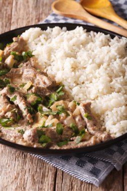 Sığır straganof pirinç yakın bir plaka üzerinde çekim ile süslenmiş. Vertica