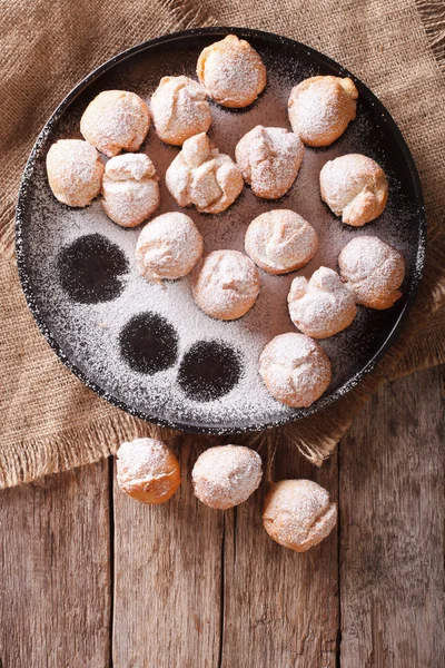 Italian donuts Castagnole on a plate on the table. vertical top — Stock Photo, Image