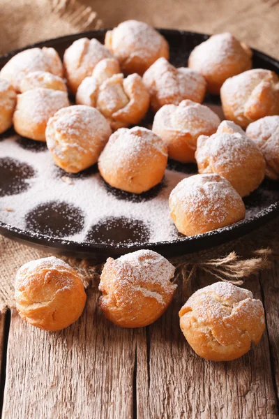 Italian sweet donuts Castagnole close-up on the table. Vertical — Stock Photo, Image