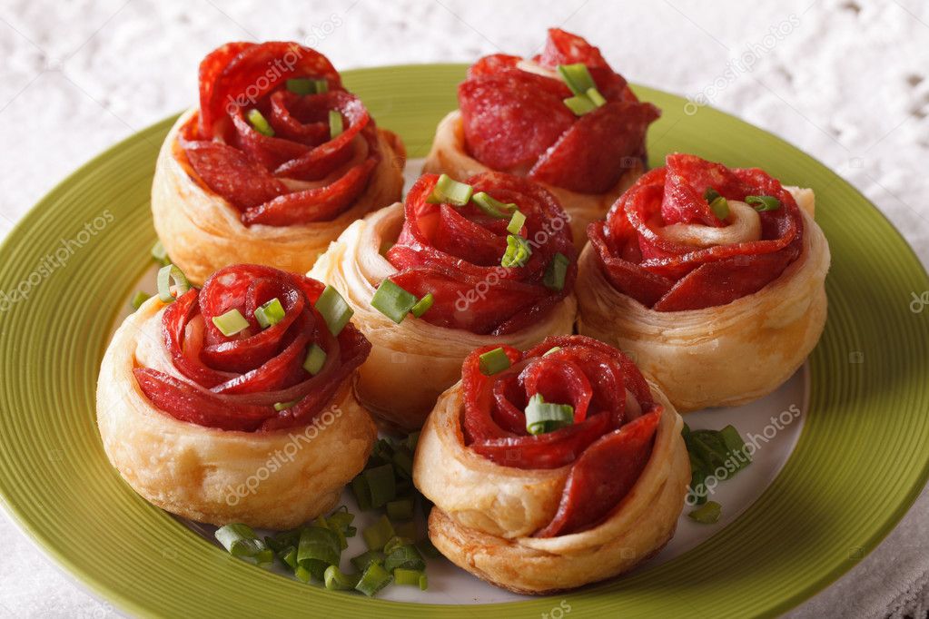 Delicious food: baked roll with salami and cheese close-up. hori