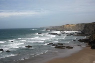 Portekiz batı kıyısında kayalar yakınındaki mavi su