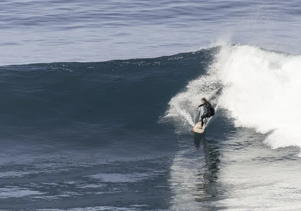 boy surfing on big waves