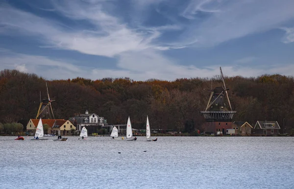 People sailing with dutch mills as background — Stock Photo, Image