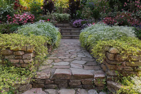 Garden with flowers at both sides of the path — Stock Photo, Image