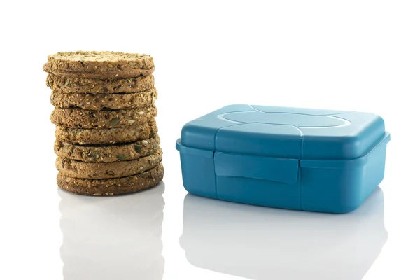 Blue lunchbox and stack of rusks — Stock Photo, Image