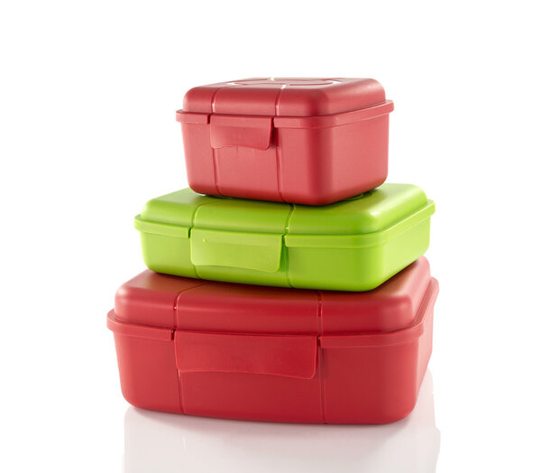 stack of red and green lunchboxes