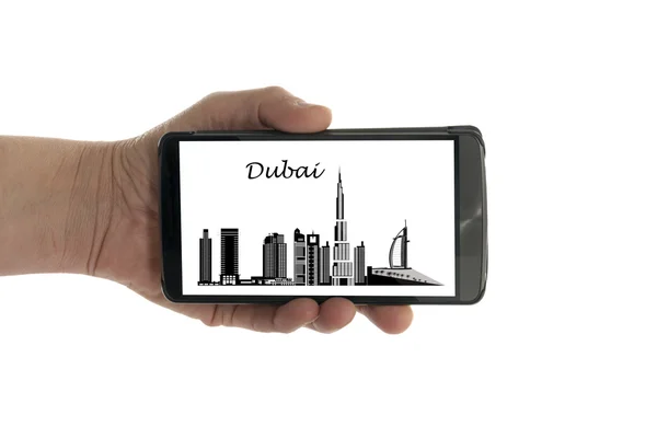 Female hand with mobile phone Dubai skyline — Stock Photo, Image