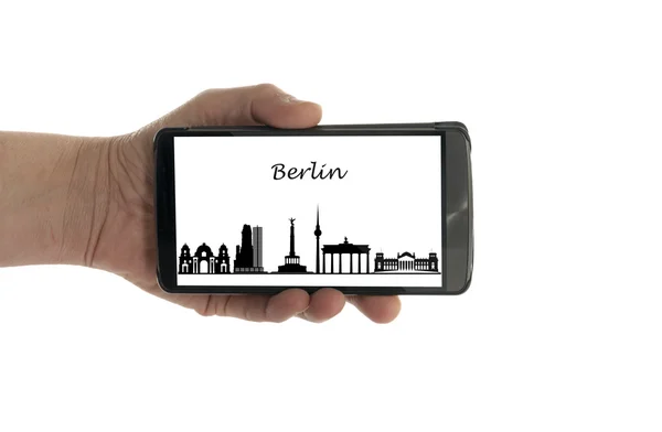 Female hand with mobile phone Berlin skyline — Stock Photo, Image