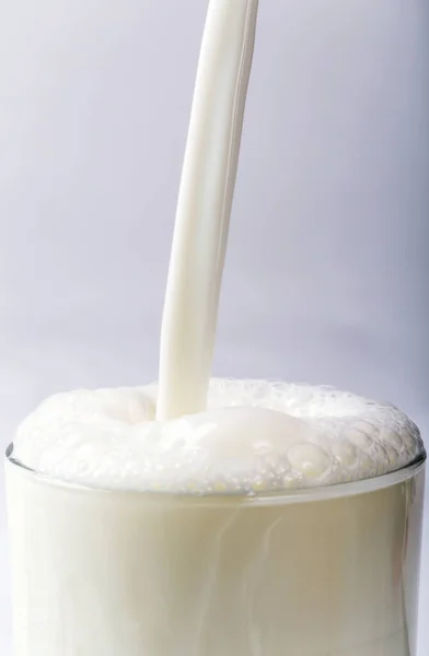 Close Milk Being Poured Glass Bubbles White Background Calgary Alberta — Stock fotografie