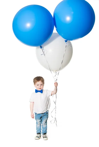 Little boy holding a bunch of colored large balloons — Stock Photo, Image