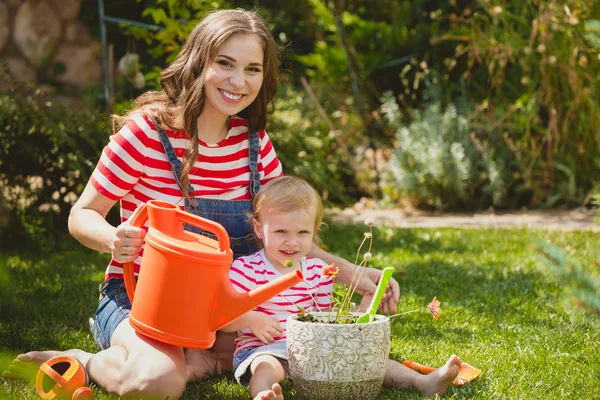 Pregnant woman with little daughter in the garden. — Stock Photo, Image