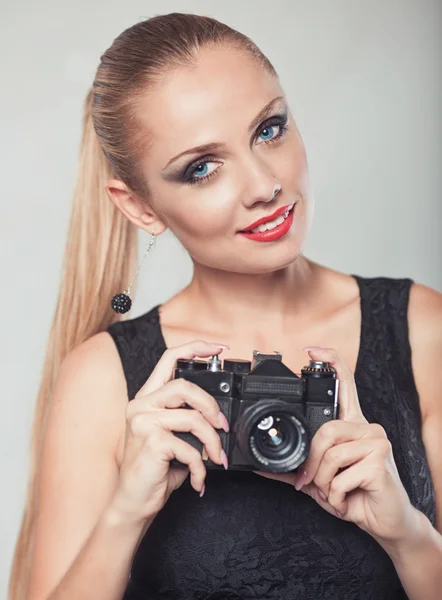 Beautiful woman with camera — Stock Photo, Image