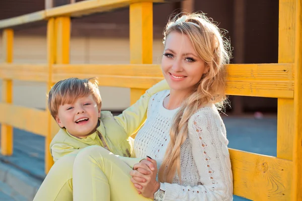 Mother with son at the autumn street — Stock Photo, Image