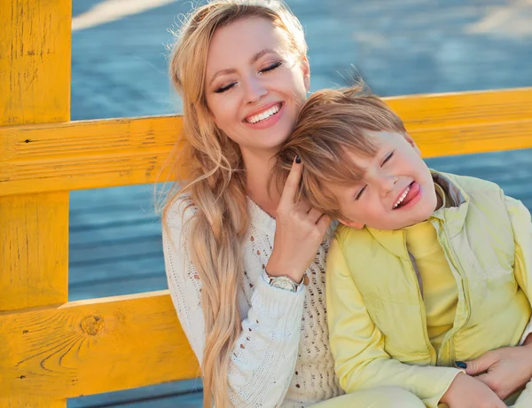 Mother with son at the autumn street — Stock Photo, Image