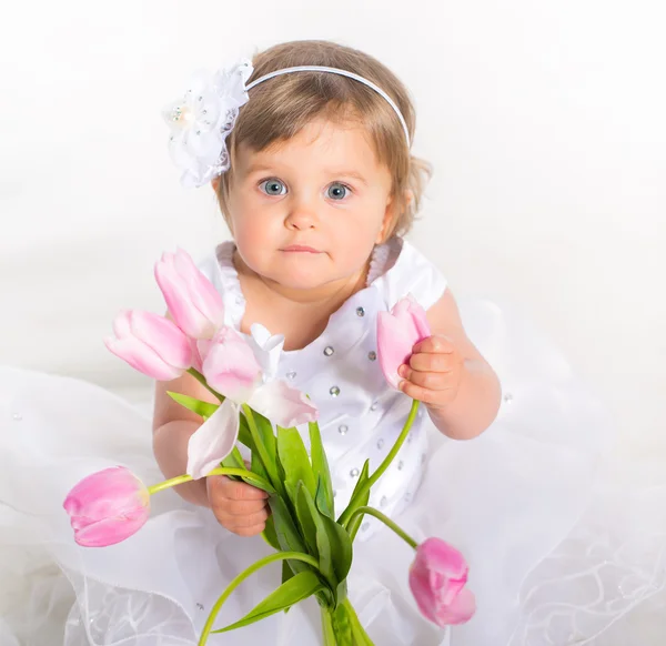 Little girl with flowers — Stock Photo, Image