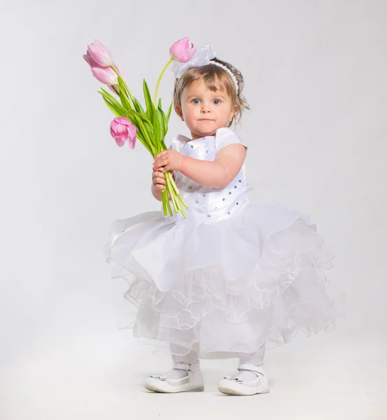 Little girl with flowers — Stock Photo, Image