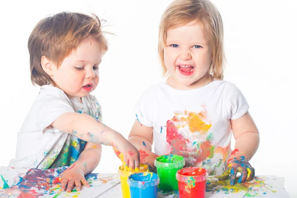 Liten pojke och flicka som leker med färger — Stockfoto