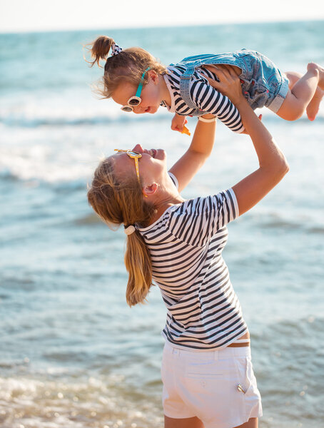 Mother with daughter on the beach