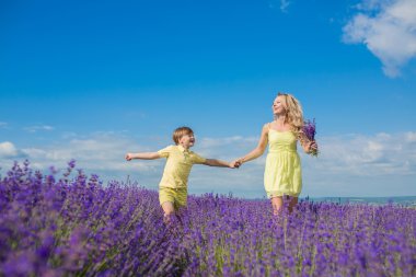 Mother with little son on lavender field