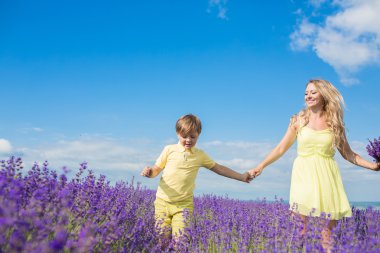 Mother with little son on lavender field
