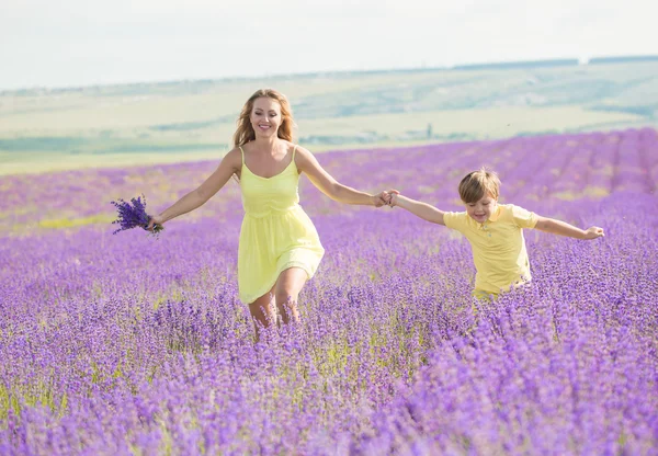 Mother with little son on lavender field — 스톡 사진