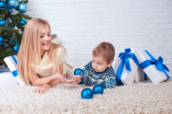 Mother with son near christmas tree — Stock Photo, Image