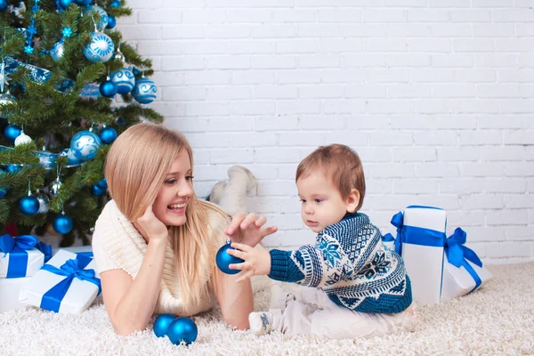 Mother with son near christmas tree — Stock Photo, Image