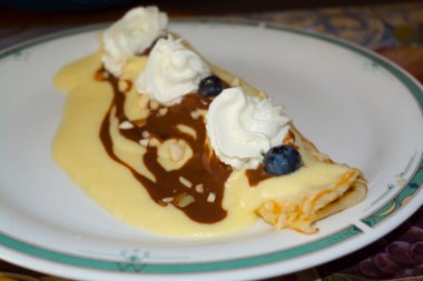 Pancake filled with curd cheese cream in vanilla dressing