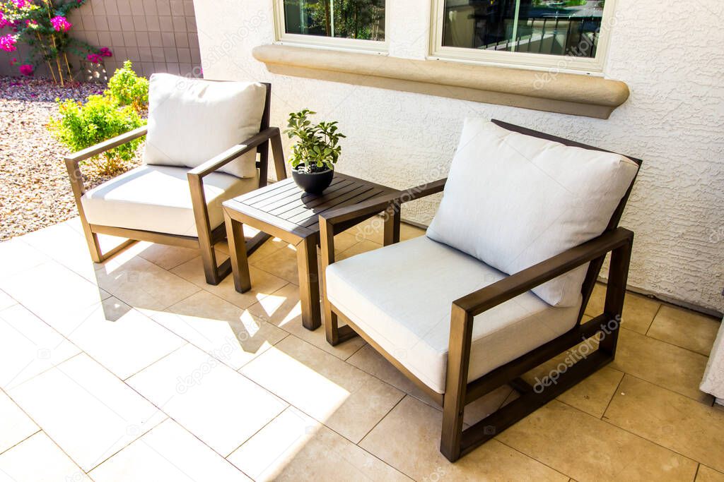 Two Front Patio Arm Chairs With Small Wooden Table
