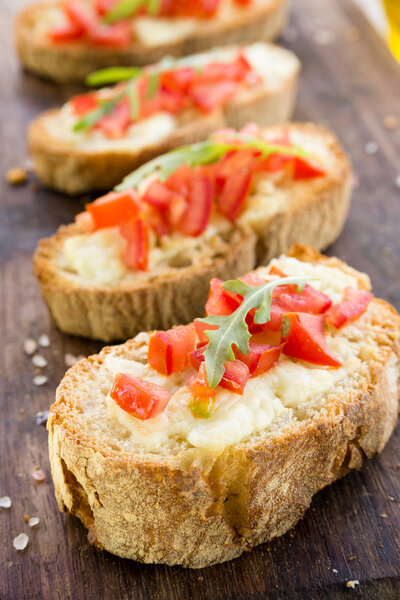 Italian bruschette with tomato and cheese