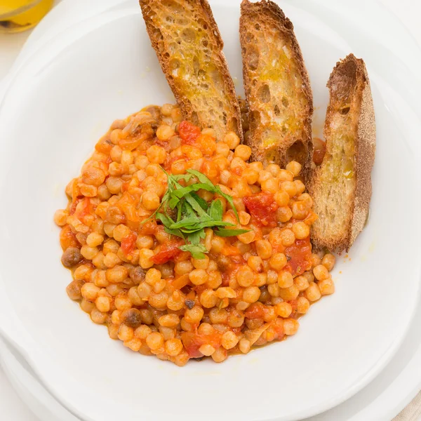 Fregola with tomato sauce, Sardinian Cuisine — Stock Photo, Image