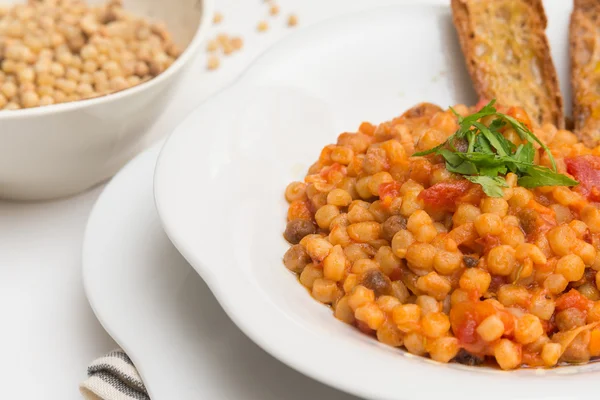 Fregola with tomato sauce, Sardinian Cuisine — Stock Photo, Image