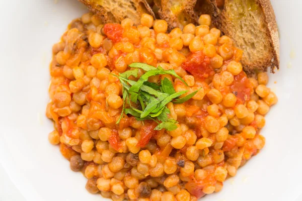 Fregola with tomato sauce, Sardinian Cuisine — Stock Photo, Image