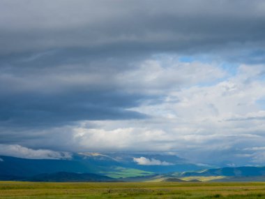 Altai Dağlarının arka planında alçak bulutlar.
