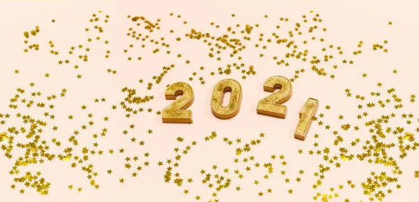 Happy New 2021 Year. Gold numbers 2021 and stars on a light background. Copy space.