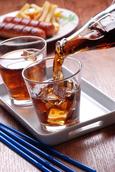 Pouring cola in glass — Stock Photo, Image