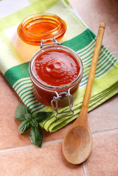 Tomato sauce in glass jar — Stock Photo, Image