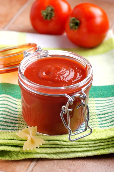 Tomato sauce in glass jar — Stock Photo, Image