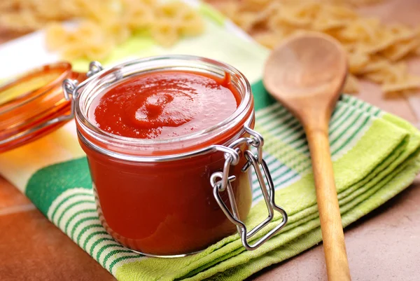 Tomato sauce in glass jar — Stock Photo, Image