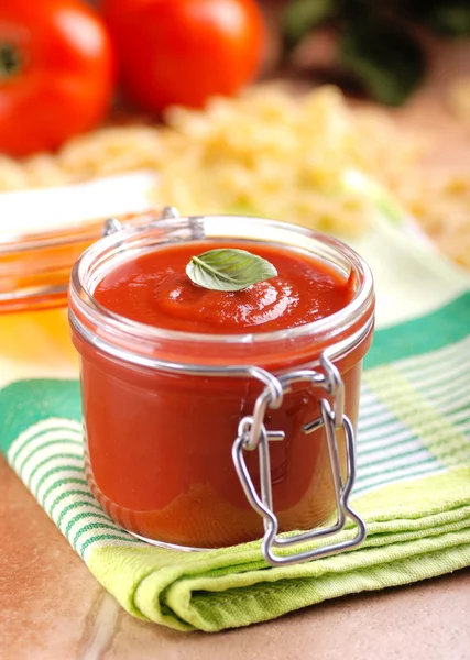 Tomato sauce in glass jar — Stock Photo, Image