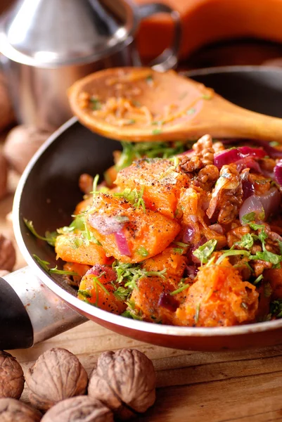 Roasted pumpkin with walnuts and onions — Stock Photo, Image