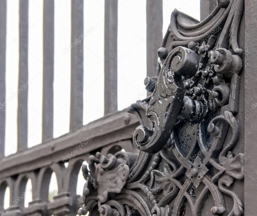 Vintage forged decorative element on metal gate.